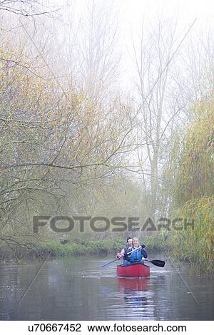 Stock Image - Couple canoeing. Fotosearch