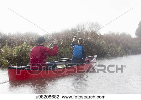 Stock Image - Couple canoeing. Fotosearch