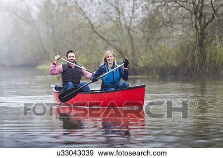 Couple canoeing View Large Photo Image Stock Photo - Couple canoeing. Fotosearch