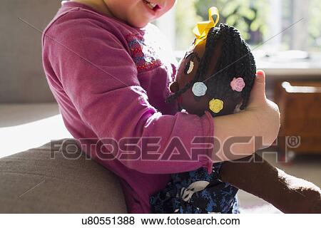 Cropped shot of baby girl in living room hugging rag doll View Large Photo Image Stock Photo - Cropped shot of baby girl in living room hugging rag doll. Fotosearch
