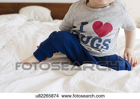 Cropped shot of baby girl wearing pyjamas sitting up in bed View Large Photo Image Picture - Cropped shot of baby girl wearing pyjamas sitting up in bed. Fotosearch
