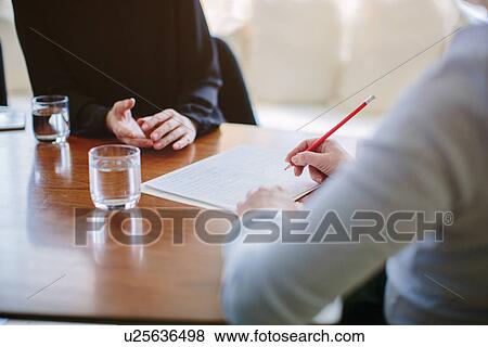 Cropped shot of mature businesswoman interviewing candidate at boardroom table View Large Photo Image Stock Photo - Cropped shot of mature businesswoman interviewing candidate at boardroom table. Fotosearch