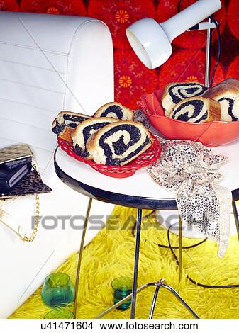 Picture - Dish of Slovenian potice on coffee table at retro party. Fotosearch