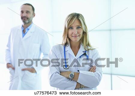 Doctors posing against backlit wall panel View Large Photo Image Stock Image - Doctors posing against backlit wall panel. Fotosearch