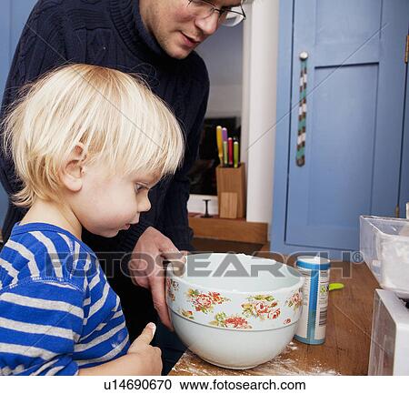 Father baking with son in kitchen View Large Photo Image Stock Image - Father baking with son in kitchen. Fotosearch