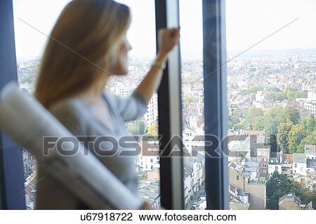 "Female architect gazing from office window at Brussels cityscape, Belgium" View Large Photo Image Stock Image - "Female architect gazing from office window at Brussels cityscape, Belgium". Fotosearch