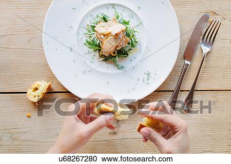 Female hands eating bread with roasted guinea fowl on greens with tarragon View Large Photo Image Stock Image - Female hands eating bread with roasted guinea fowl on greens with tarragon. Fotosearch