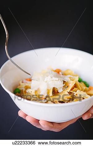 "Female hands holding bowl of fresh pasta with carrots, peas and grated cheese" View Large Photo Image Stock Photograph - "Female hands holding bowl of fresh pasta with carrots, peas and grated cheese". Fotosearch