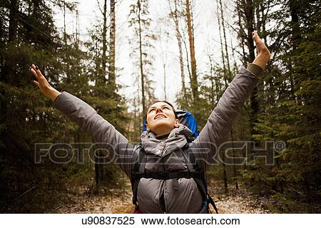"Female hiker with arms raised in forest, Sarsy Village, Sverdlovsk Oblast, Russia" View Large Photo Image Stock Photography - "Female hiker with arms raised in forest, Sarsy Village, Sverdlovsk Oblast, Russia". Fotosearch
