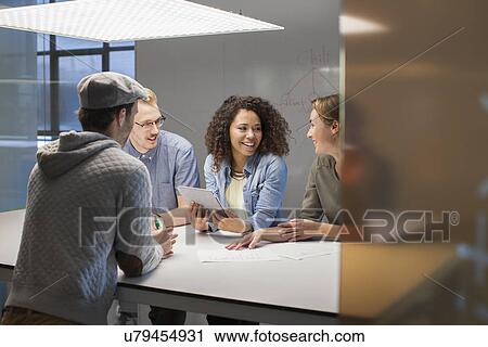 Four creative colleagues meeting at conference table View Large Photo Image Stock Image - Four creative colleagues meeting at conference table. Fotosearch