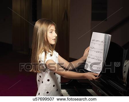 Girl choosing sheet music for piano View Large Photo Image Stock Photo - Girl choosing sheet music for piano. Fotosearch