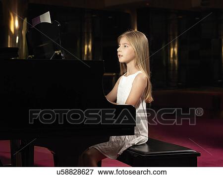 Girl playing piano on stage View Large Photo Image Stock Photo - Girl playing piano on stage. Fotosearch