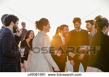 Group of friends drinking and dancing at party View Large Photo Image Stock Image - Group of friends drinking and dancing at party. Fotosearch