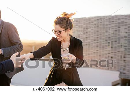 Group of friends drinking and dancing at party View Large Photo Image Stock Image - Group of friends drinking and dancing at party. Fotosearch