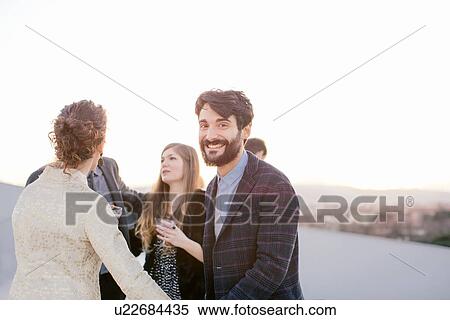 Group of friends drinking together at party View Large Photo Image Stock Photography - Group of friends drinking together at party. Fotosearch