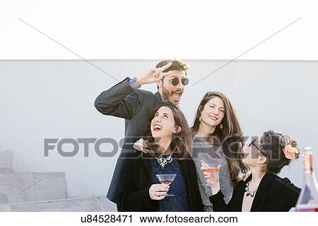Group of friends fooling around at party View Large Photo Image Stock Image - Group of friends fooling around at party. Fotosearch