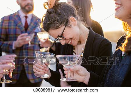 Group of friends laughing and drinking at party View Large Photo Image Stock Photo - Group of friends laughing and drinking at party. Fotosearch