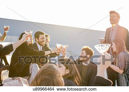 Picture - Group of friends making a toast at party. Fotosearch