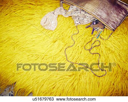 Handbag and house keys on yellow furry rug View Large Photo Image Stock Image - Handbag and house keys on yellow furry rug. Fotosearch