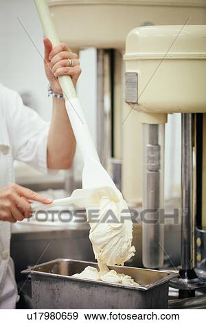 Stock Photo - "Hands of female artisan preparing fresh gelato, Tuscany, Italy". Fotosearch