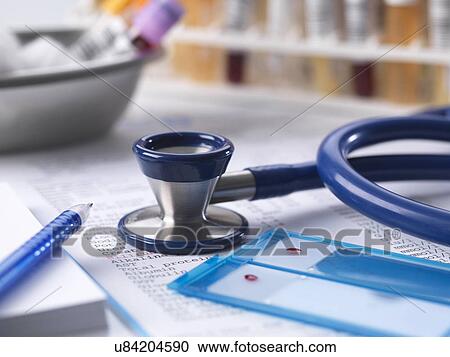 Stock Image - "Health check with stethoscope, results, blood, urine and chem samples on doctors desk". Fotosearch
