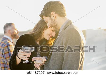 Heterosexual couple flirting at party View Large Photo Image Stock Photo - Heterosexual couple flirting at party. Fotosearch