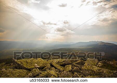 Stock Image - "Landscape view of distant mountains at dawn, Sarsy Village, Sverdlovsk Oblast, Russia". Fotosearch