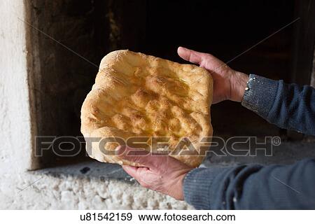 Male hands holding Tuscan flat bread View Large Photo Image Stock Photo - Male hands holding Tuscan flat bread. Fotosearch