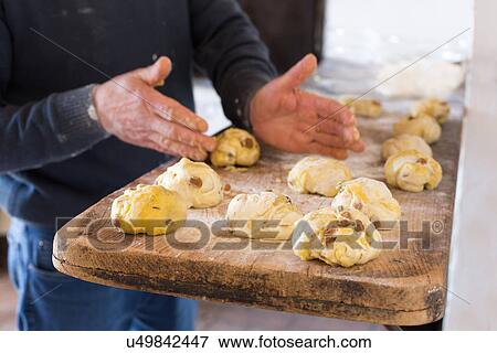 Stock Photo - "Male hands shaping Tuscan panini with walnuts, raisins and rosemary". Fotosearch