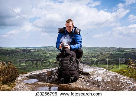 "Male hiker with camping stove on top of Guise Cliff, Pateley Bridge, Nidderdale, Yorkshire Dales" View Large Photo Image Stock Photograph - "Male hiker with camping stove on top of Guise Cliff, Pateley Bridge, Nidderdale, Yorkshire Dales". Fotosearch