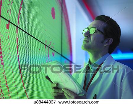 Male scientist with silicon wafer studying graphical display of wafer on screens View Large Photo Image Stock Photo - Male scientist with silicon wafer studying graphical display of wafer on screens. Fotosearch