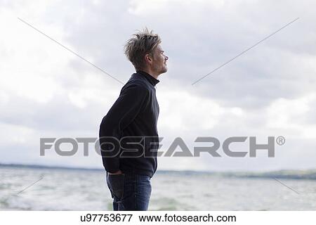 "Man looking out from lakeside, Lake Starnberg, Bavaria, Germany" View Large Photo Image Stock Photo - "Man looking out from lakeside, Lake Starnberg, Bavaria, Germany". Fotosearch
