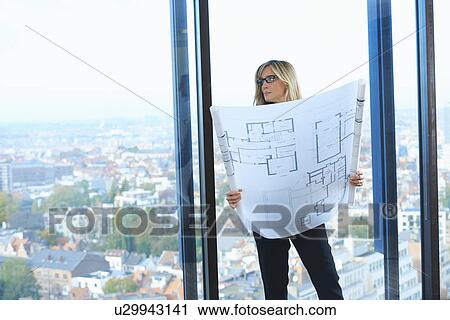 "Mature architect in front of office window with Brussels cityscape, Belgium" View Large Photo Image Stock Image - "Mature architect in front of office window with Brussels cityscape, Belgium". Fotosearch
