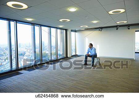 "Mature businessman looking from empty office window at Brussels cityscape, Belgium" View Large Photo Image Stock Photo - "Mature businessman looking from empty office window at Brussels cityscape, Belgium". Fotosearch
