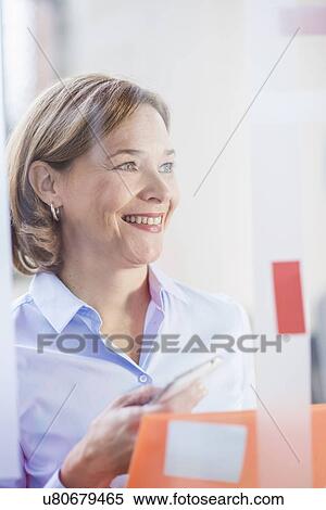Mature businesswoman in office View Large Photo Image Stock Photography - Mature businesswoman in office. Fotosearch
