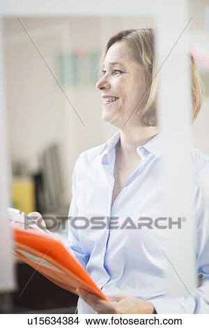 Mature businesswoman with file and smartphone View Large Photo Image Picture - Mature businesswoman with file and smartphone. Fotosearch