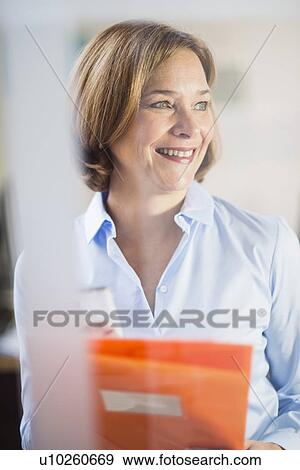 Mature businesswoman with smartphone and paperwork View Large Photo Image Stock Photo - Mature businesswoman with smartphone and paperwork. Fotosearch