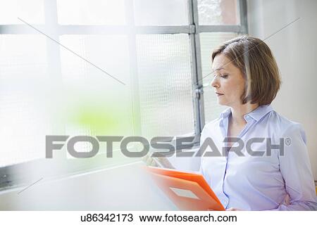Mature businesswoman with texting on smartphone View Large Photo Image Stock Image - Mature businesswoman with texting on smartphone. Fotosearch