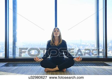 Mature woman practising yoga in room View Large Photo Image Stock Photo - Mature woman practising yoga in room. Fotosearch