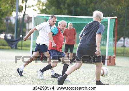 Picture - Men playing football. Fotosearch