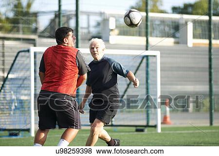 Men playing football View Large Photo Image Stock Photo - Men playing football. Fotosearch