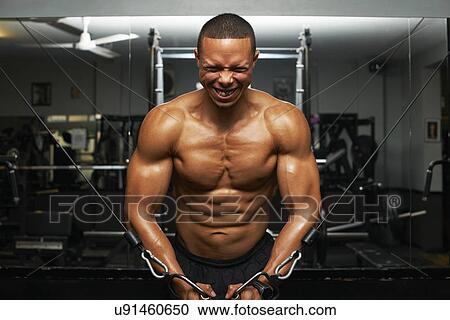 "Mid adult man, lifting weights, rear view" View Large Photo Image Stock Image - "Mid adult man, lifting weights, rear view". Fotosearch