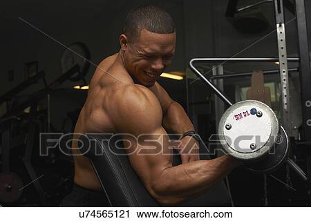 "Mid adult man, lifting weights" View Large Photo Image Stock Image - "Mid adult man, lifting weights". Fotosearch