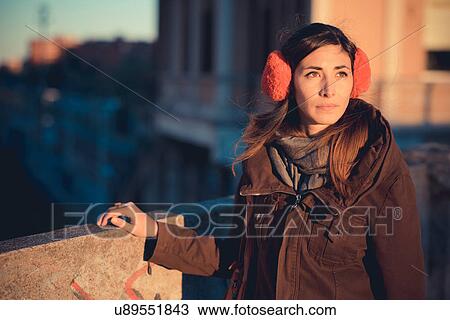 Mid adult woman wearing red ear muffs on city roof top View Large Photo Image Stock Image - Mid adult woman wearing red ear muffs on city roof top. Fotosearch