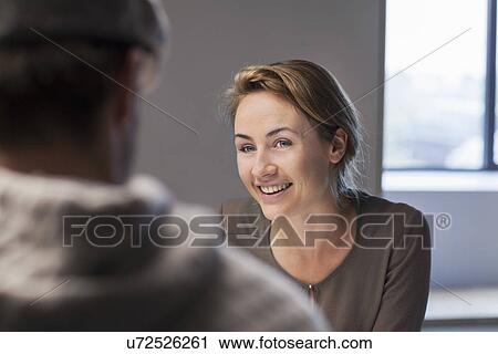 Over shoulder view of man and woman at meeting View Large Photo Image Stock Image - Over shoulder view of man and woman at meeting. Fotosearch