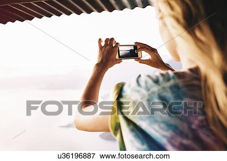 "Over shoulder view of young woman photographing Lake Atitlan, Guatemala" View Large Photo Image Stock Photo - "Over shoulder view of young woman photographing Lake Atitlan, Guatemala". Fotosearch