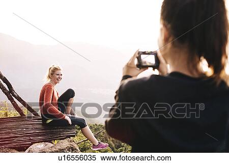 "Over shoulder view of young woman photographing friend at Lake Atitlan, Guatemala" View Large Photo Image Stock Photography - "Over shoulder view of young woman photographing friend at Lake Atitlan, Guatemala". Fotosearch