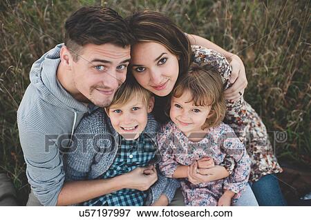 Overhead portrait of young couple with son and daughter in field View Large Photo Image Stock Photo - Overhead portrait of young couple with son and daughter in field. Fotosearch