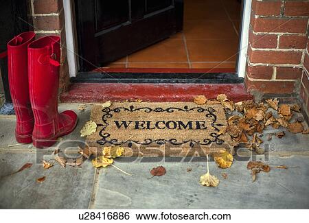 Pair of red boots next to welcome doormat View Large Photo Image Stock Photograph - Pair of red boots next to welcome doormat. Fotosearch