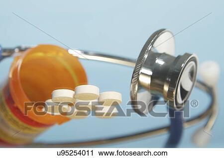 Stock Image - "Pills and acoustic stethoscope, close-up". Fotosearch